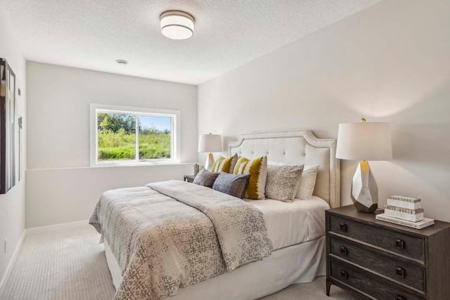 carpeted bedroom with a textured ceiling