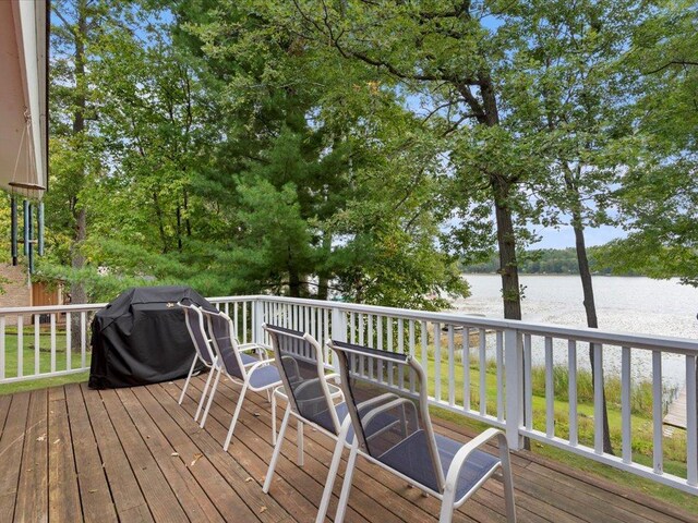 wooden deck featuring a water view and area for grilling