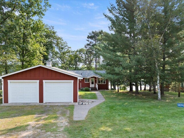 single story home featuring a garage and a front lawn