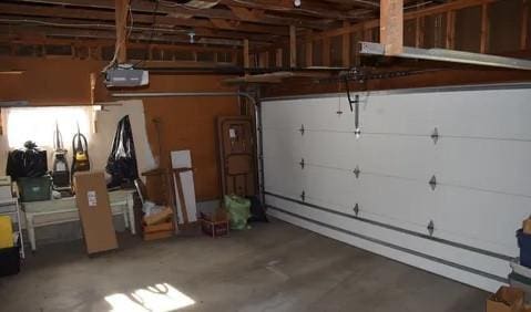 garage with baseboard heating and a garage door opener