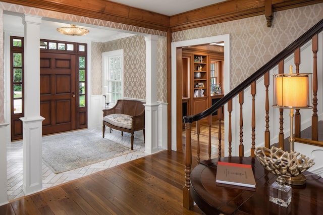 entrance foyer featuring hardwood / wood-style floors and decorative columns