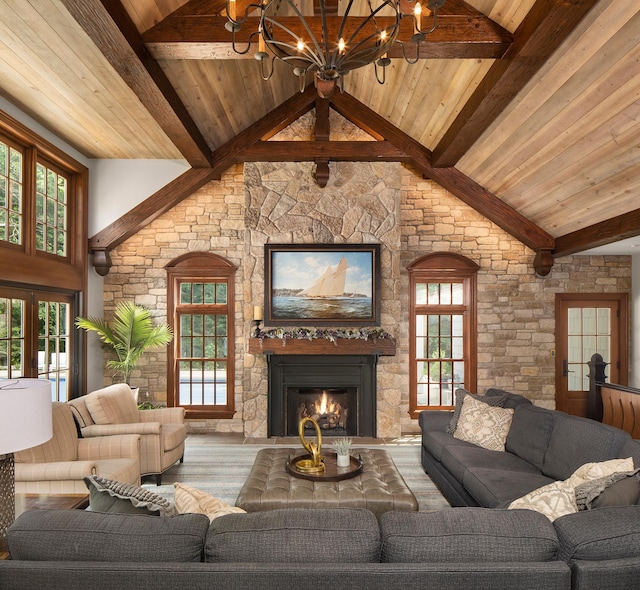 living room with high vaulted ceiling, a wealth of natural light, a fireplace, and beamed ceiling