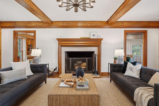 living room featuring beam ceiling, an inviting chandelier, and light wood-type flooring