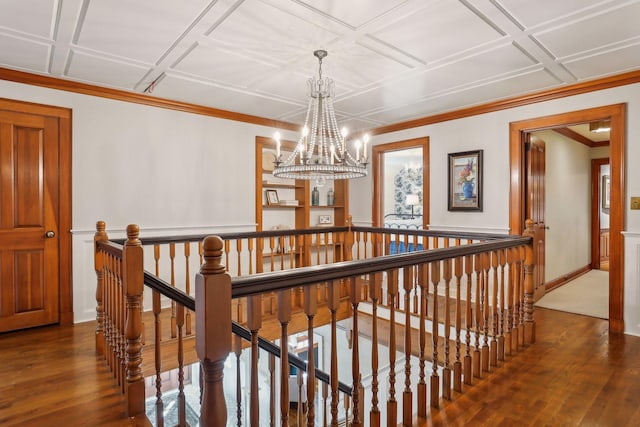 hallway with hardwood / wood-style flooring, a chandelier, and coffered ceiling