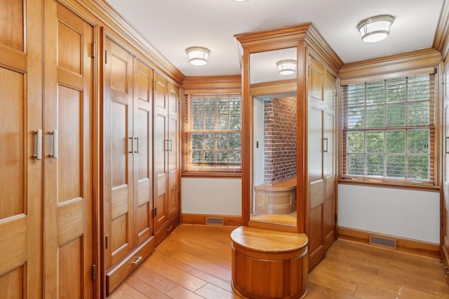 doorway featuring light hardwood / wood-style flooring and ornamental molding