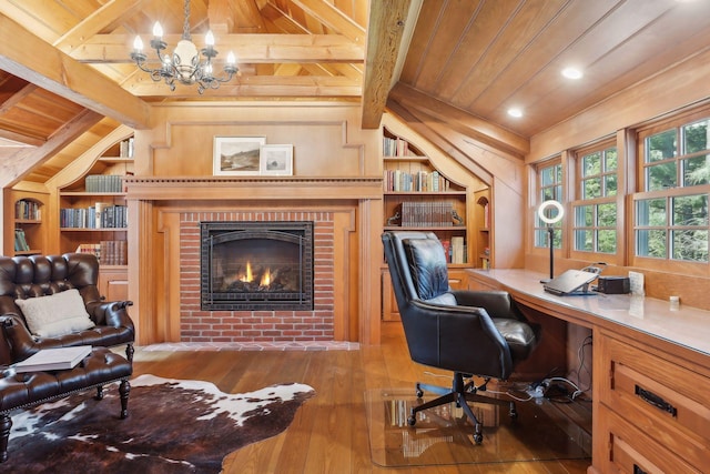 office space with hardwood / wood-style floors, wood ceiling, built in shelves, a fireplace, and vaulted ceiling with beams