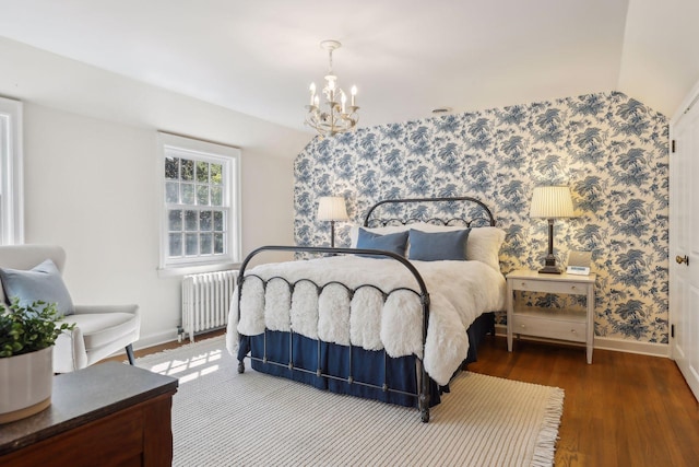 bedroom with lofted ceiling, radiator heating unit, dark hardwood / wood-style flooring, and a notable chandelier