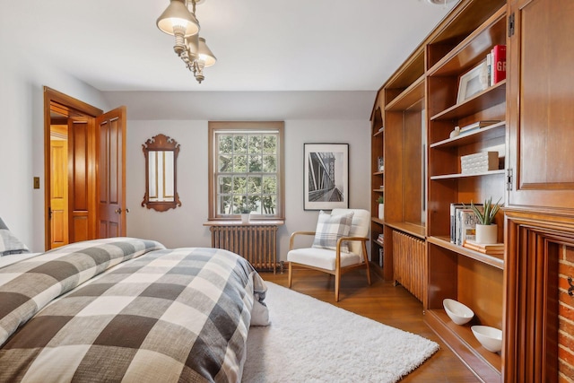 bedroom featuring radiator and dark hardwood / wood-style flooring