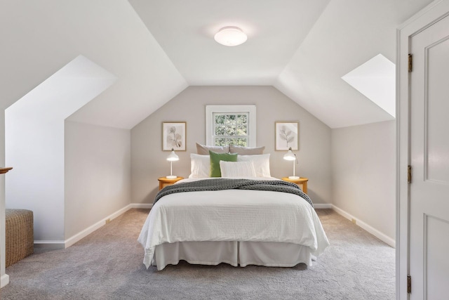 bedroom featuring lofted ceiling and light colored carpet