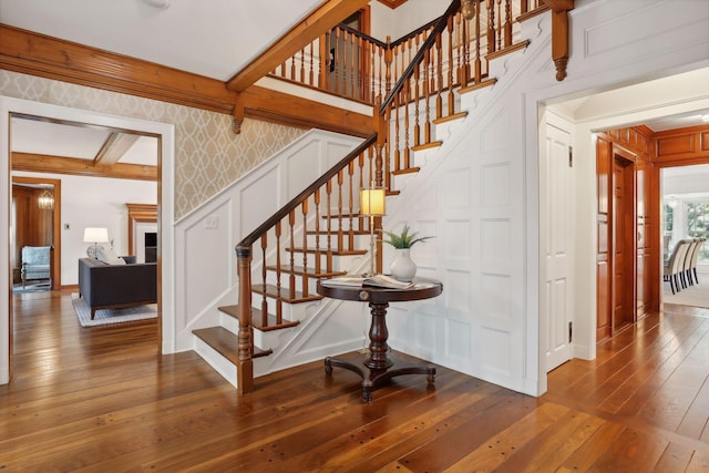 357 Salem Church Rd, Sunfish Lake, MN 55118 - stairs with crown molding, a decorative wall, hardwood / wood-style floors, wallpapered walls, and baseboards