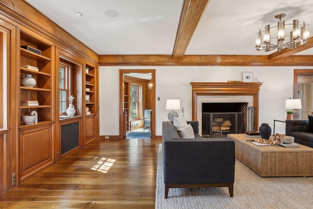 357 Salem Church Rd, Sunfish Lake, MN 55118 - living area featuring a fireplace, built in shelves, beam ceiling, an inviting chandelier, and hardwood / wood-style floors