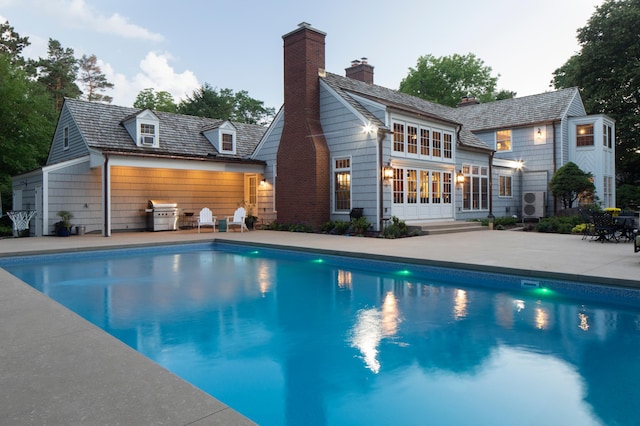 357 Salem Church Rd, Sunfish Lake, MN 55118 - back of property with a chimney, an outdoor pool, and a patio area