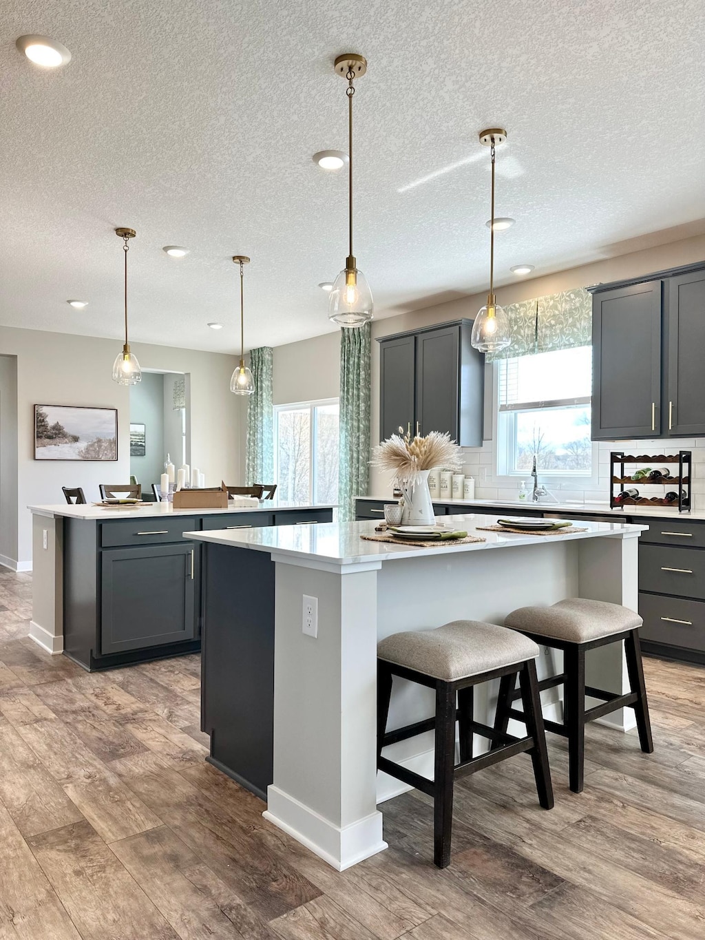 kitchen featuring pendant lighting, a large island, and gray cabinetry