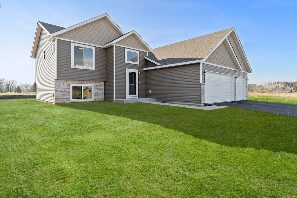 view of front of property featuring a garage and a front yard