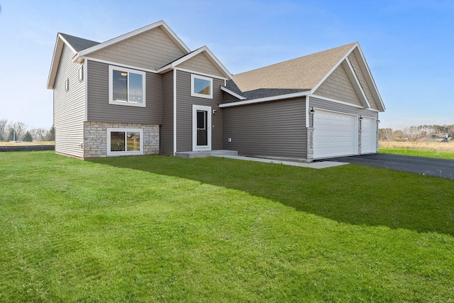 view of front of property featuring a garage and a front yard