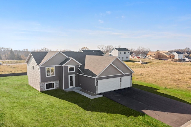 view of front of house featuring a garage and a front lawn