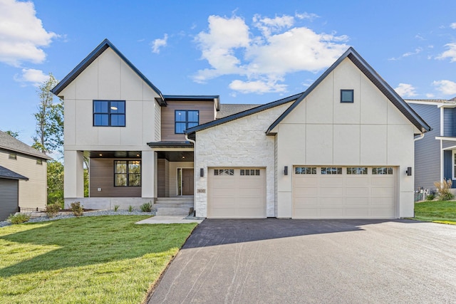 modern farmhouse style home featuring a garage and a front lawn