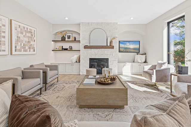 living room featuring a fireplace and light hardwood / wood-style floors