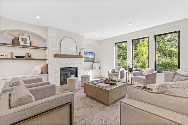 living room featuring light wood-type flooring and a fireplace