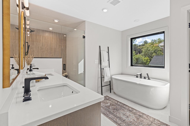 bathroom featuring vanity, plus walk in shower, and tile patterned flooring