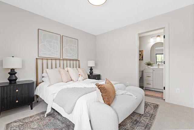 bedroom featuring carpet flooring and connected bathroom