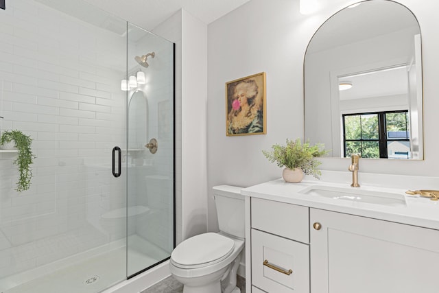 bathroom with vanity, toilet, and an enclosed shower