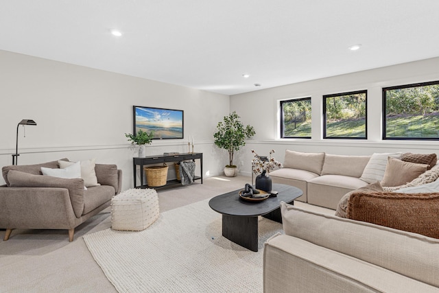 living room featuring a healthy amount of sunlight and light carpet