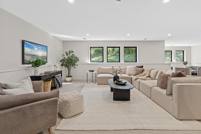 carpeted living room featuring plenty of natural light