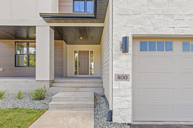 property entrance with a garage and a porch