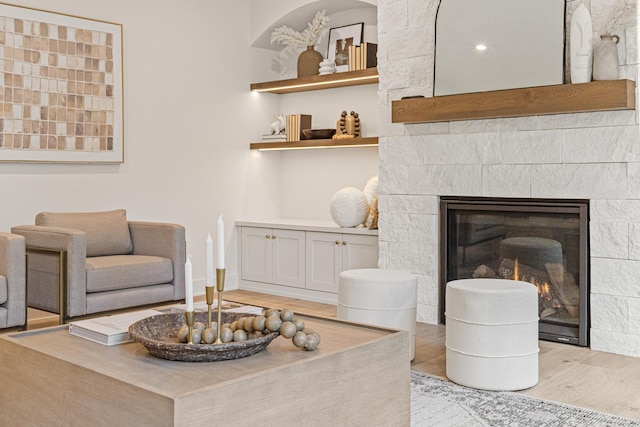 living room featuring light hardwood / wood-style flooring and a fireplace