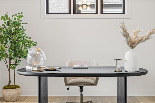 home office with light hardwood / wood-style flooring