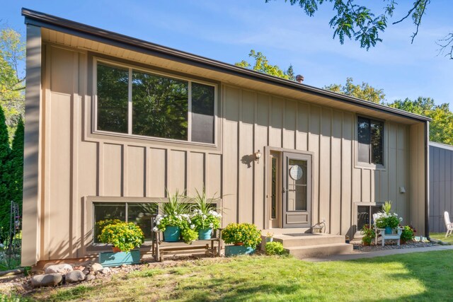 rear view of house featuring a yard