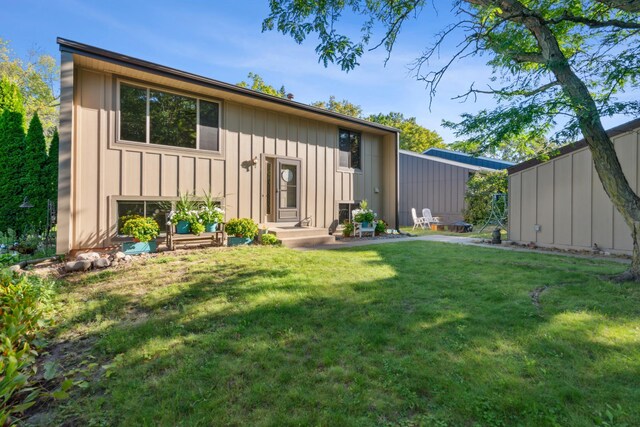 rear view of property with a yard