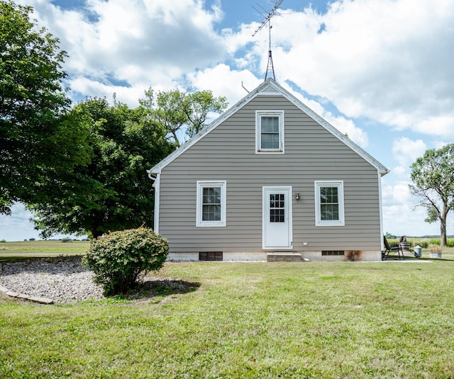 rear view of property with a yard