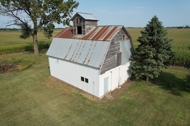 view of outbuilding featuring a yard and a rural view