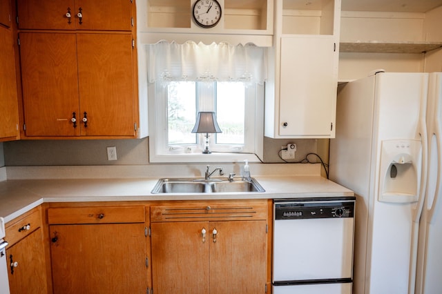 kitchen featuring white appliances and sink