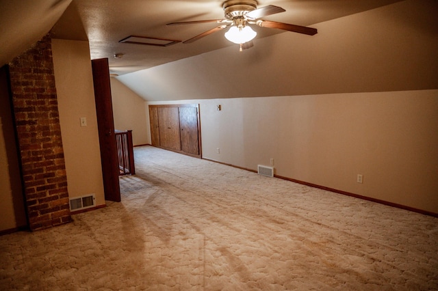 additional living space with ceiling fan, light carpet, and vaulted ceiling