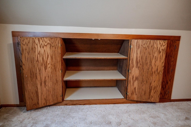 stairs featuring vaulted ceiling and carpet flooring