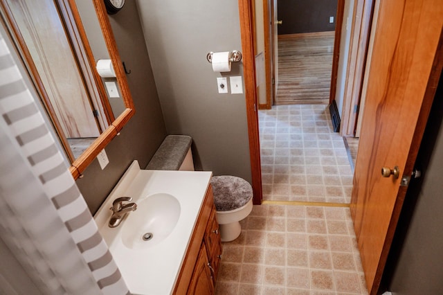 bathroom featuring vanity and toilet