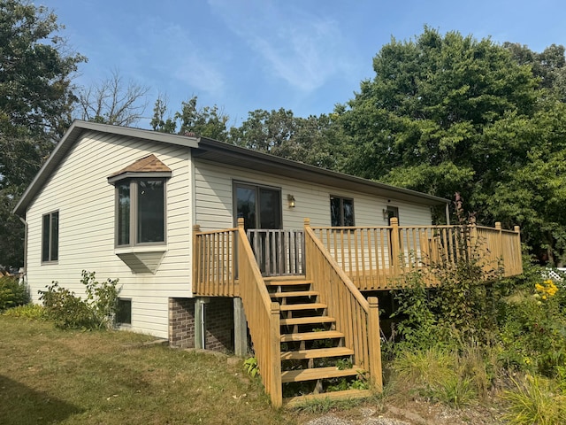 rear view of house with a wooden deck