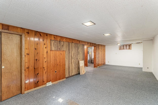 basement featuring wood walls