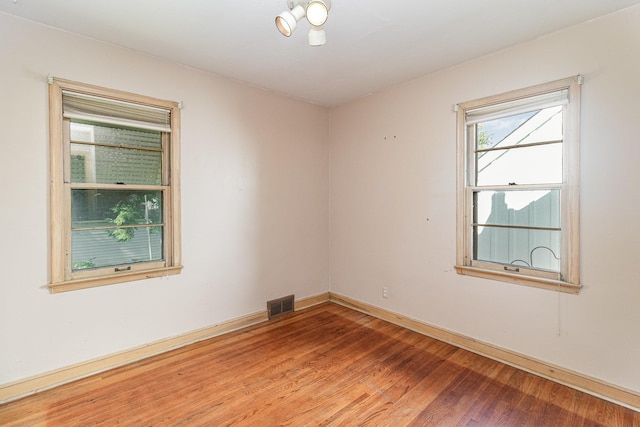 unfurnished room with hardwood / wood-style floors