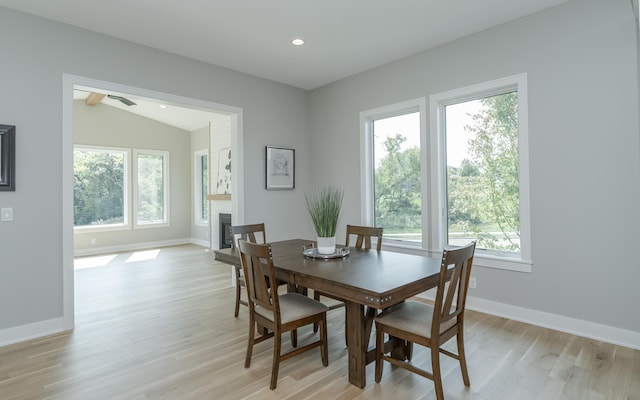 dining space featuring a wealth of natural light, vaulted ceiling, and light hardwood / wood-style floors