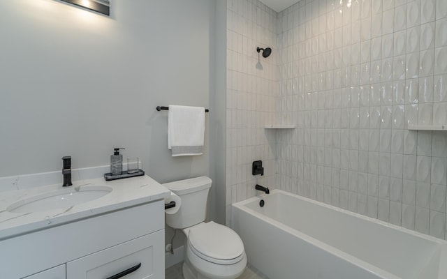 full bathroom with vanity, tiled shower / bath, and toilet