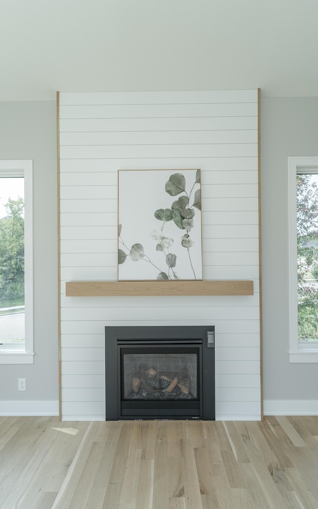 interior details with a fireplace and wood-type flooring