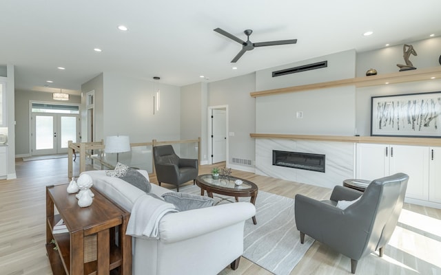 living room with french doors, light hardwood / wood-style flooring, and ceiling fan