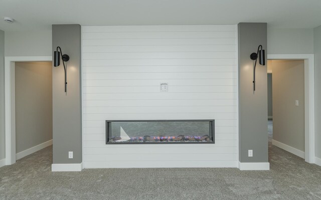 interior details featuring a fireplace and carpet floors