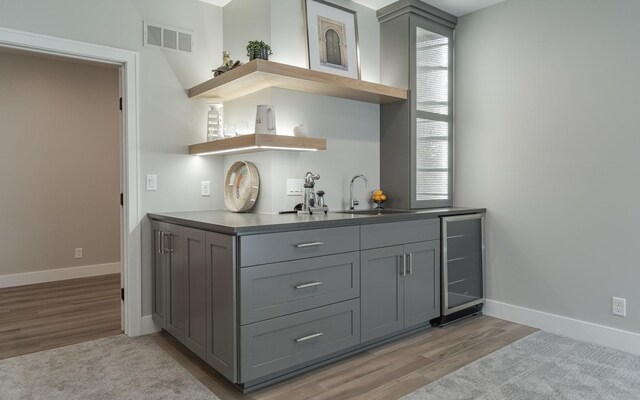 interior space featuring sink, gray cabinets, and light wood-type flooring