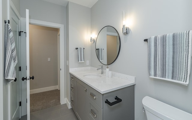 bathroom with vanity, toilet, and tile patterned flooring