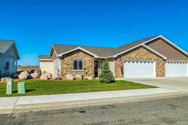 ranch-style house featuring a garage and a front lawn